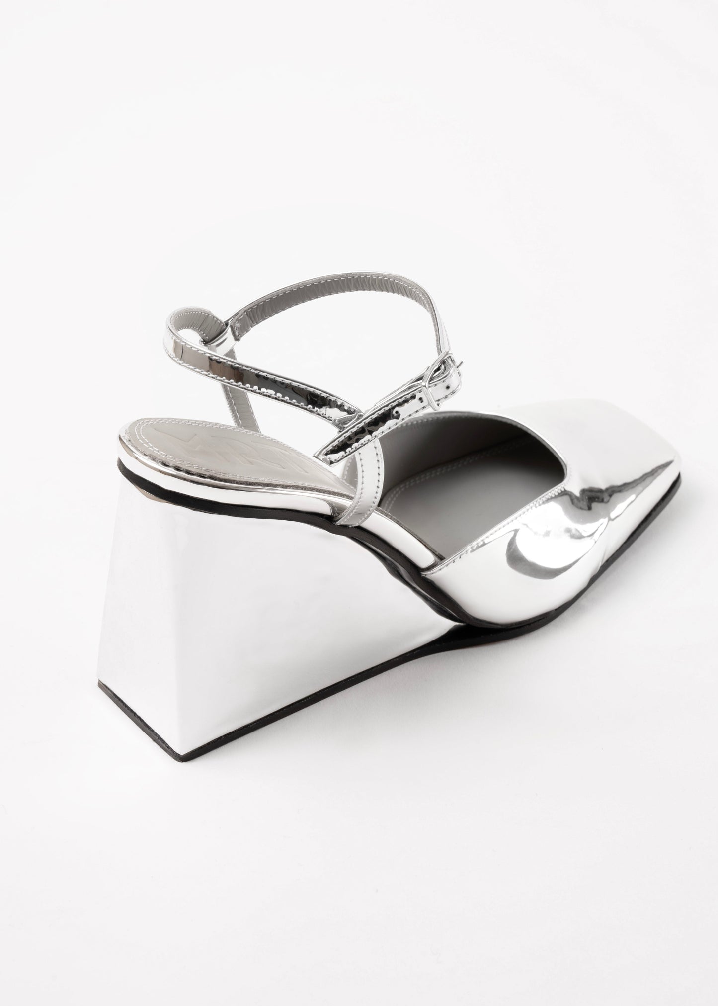 Silver high-heeled shoes on a white background