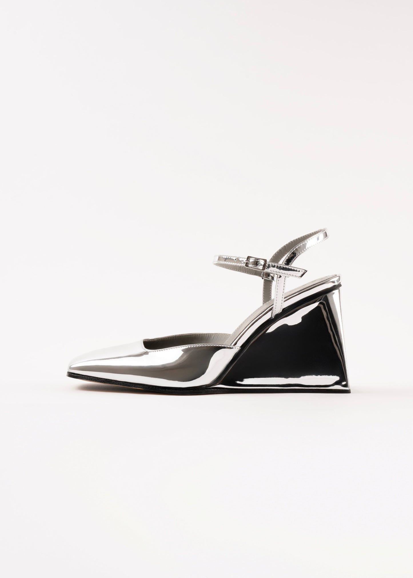 Shiny silver high-heeled shoe on a white background