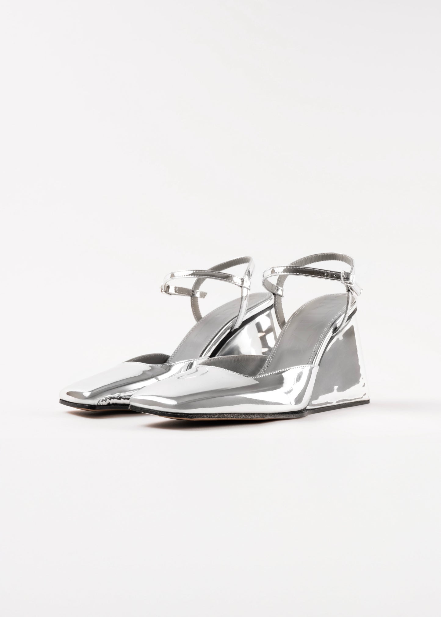 Silver high-heeled shoes on a white background