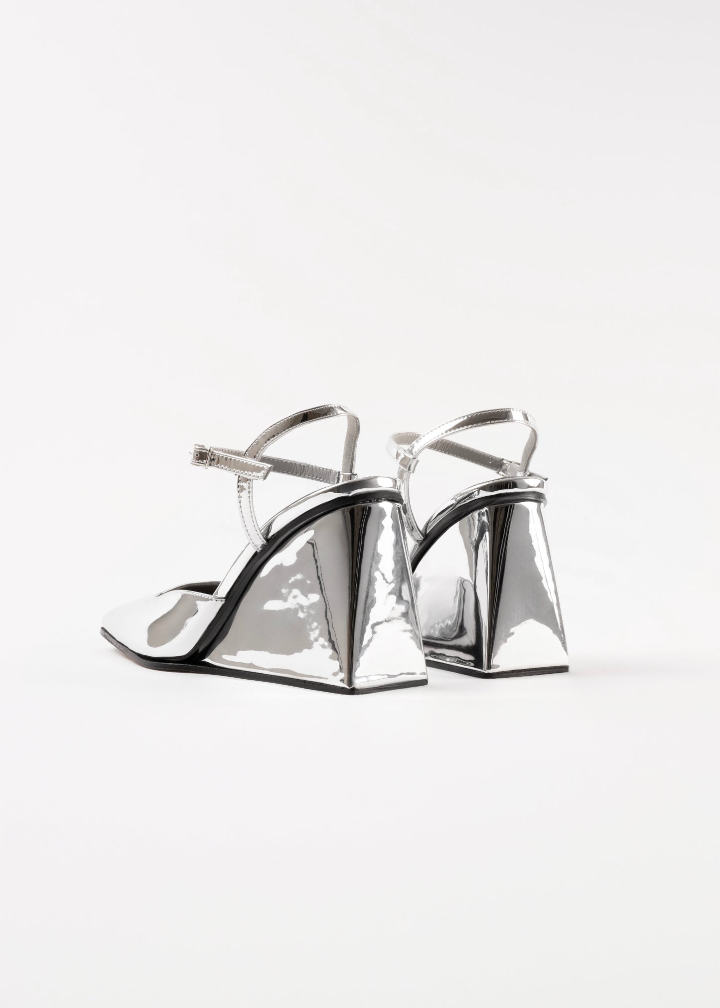 Silver high-heeled shoes on a white background