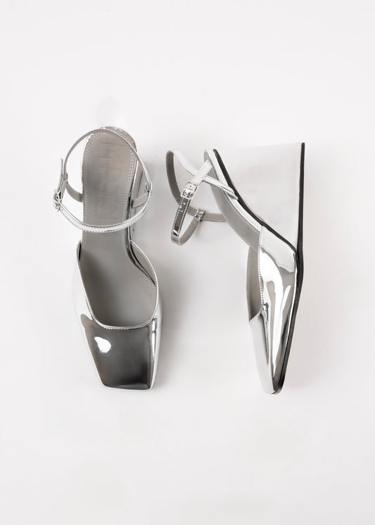 Pair of silver high-heeled shoes on a white background