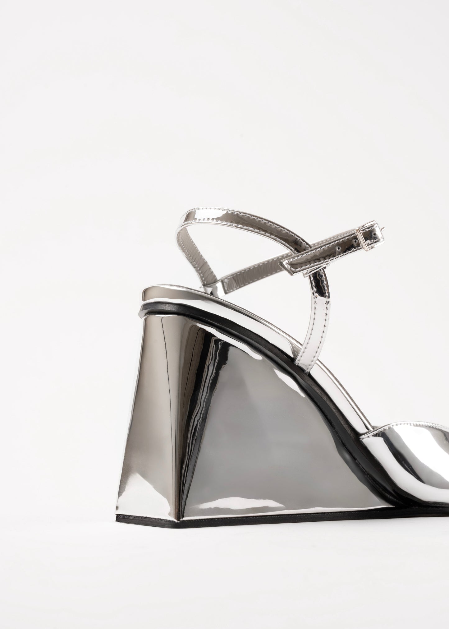 Silver wedge sandal on a white background
