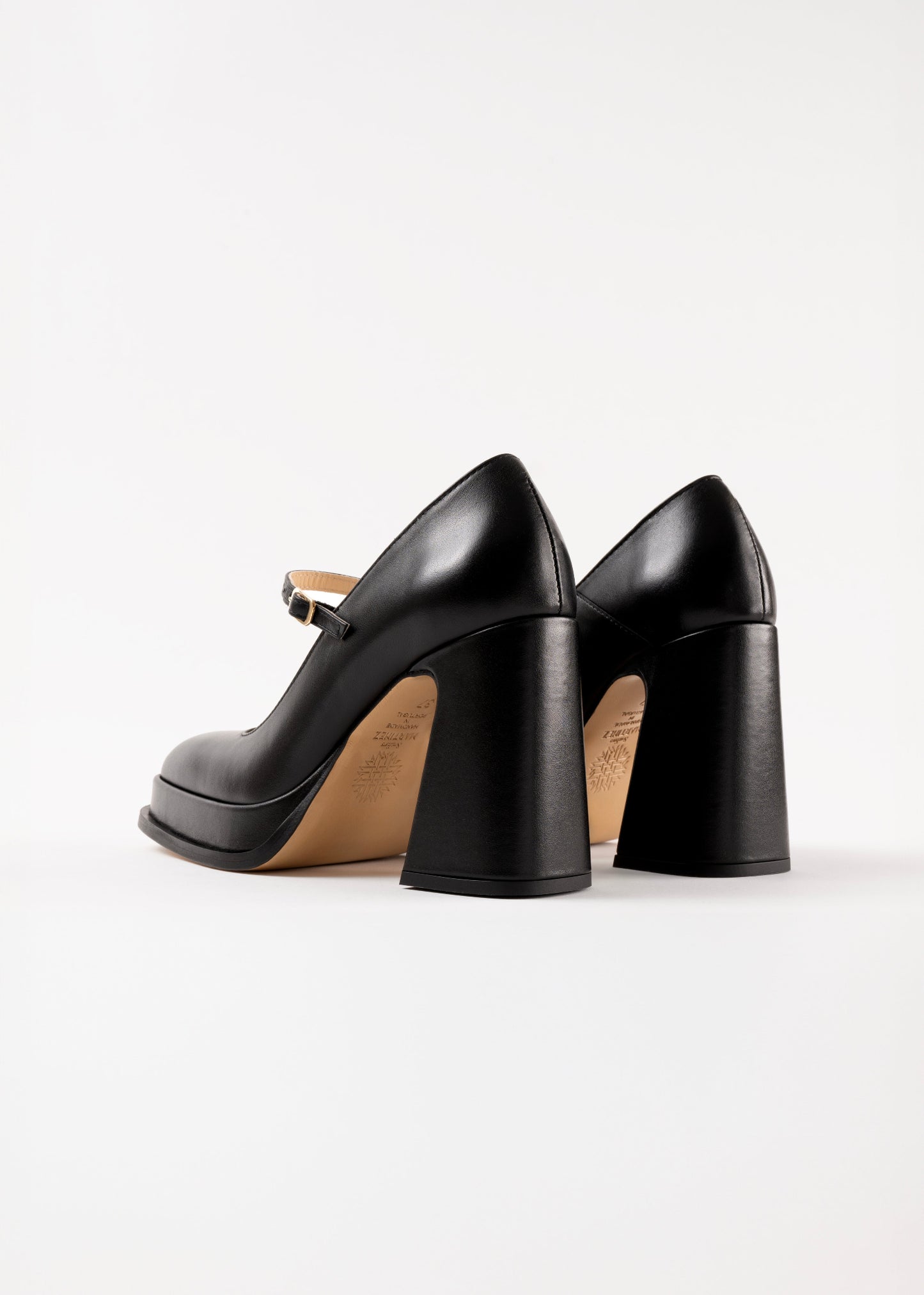 Black high-heeled shoes on a white background