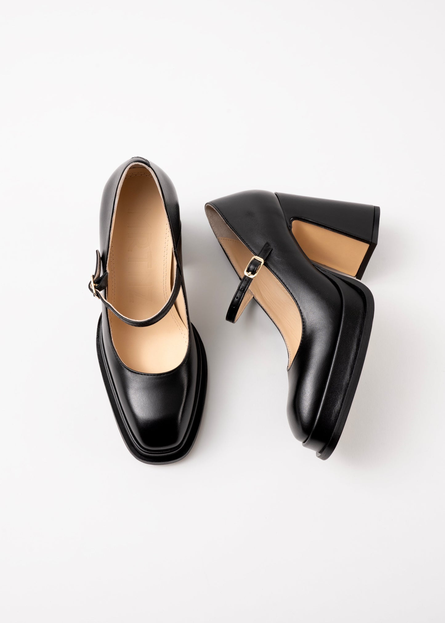Pair of black high-heeled shoes on a white background
