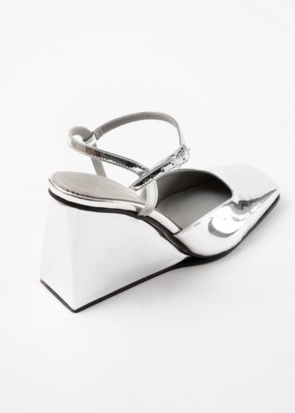 Silver high-heeled shoes on a white background