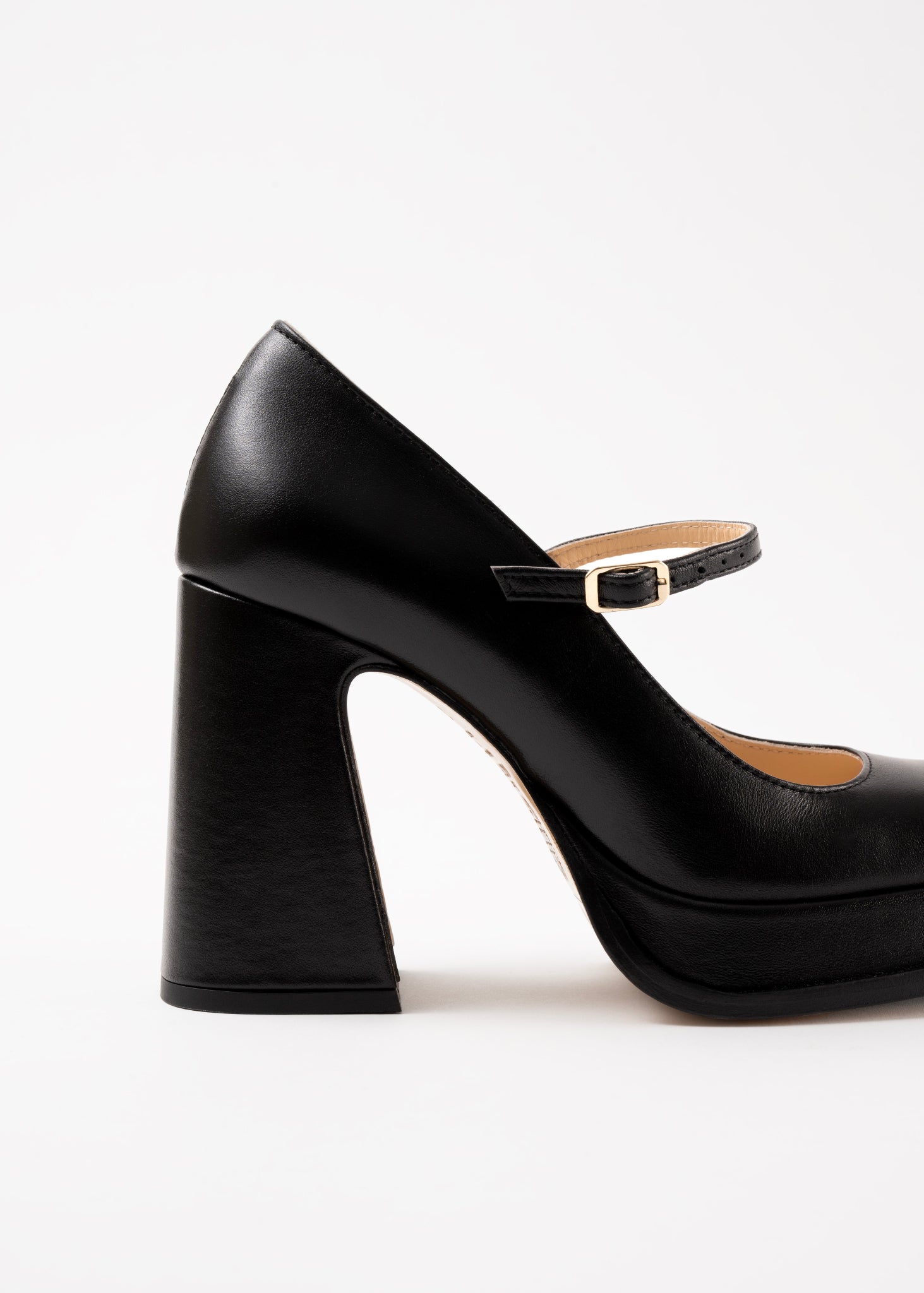 Black high-heeled shoe with a strap on a white background