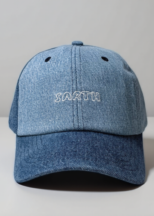 Blue denim cap with 'SARTH' embroidery on a light gray background
